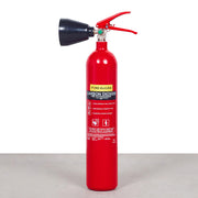 A red 2KG CO2 fire extinguisher with a black horn-shaped nozzle and a green label that includes instructions - fire guard