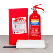 A red fire extinguisher labeled '2KG AB Dry Powder' and a white fire blanket labeled 'FIRE BLANKET' with instructions and a pull tape, placed next to each other.