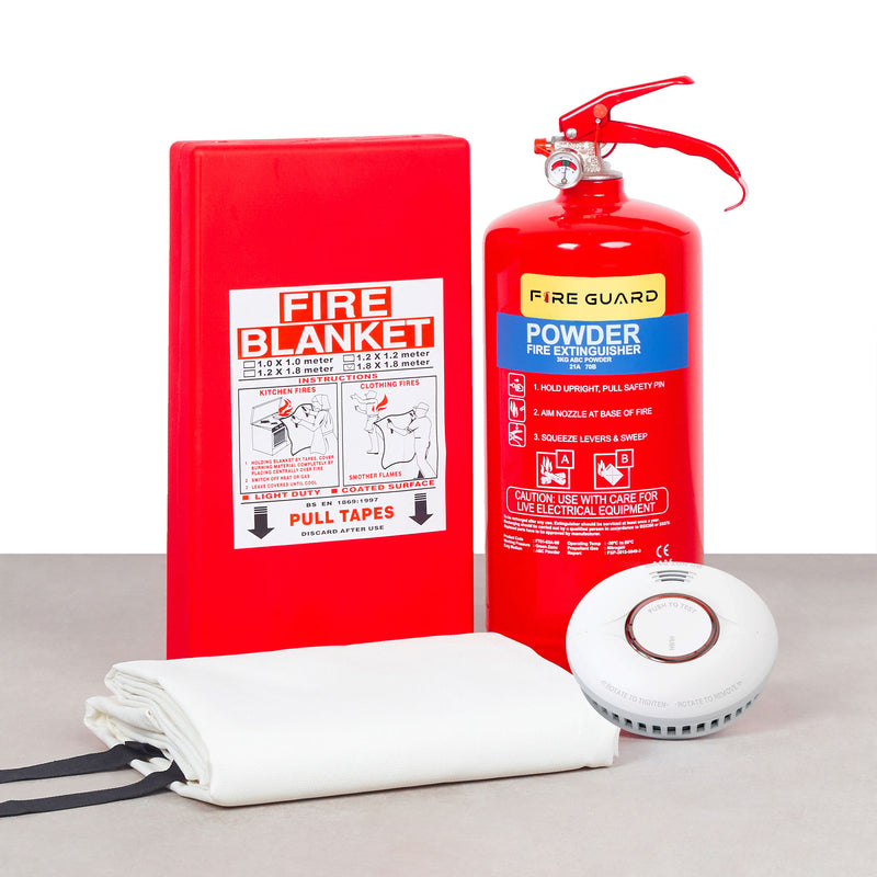 A home fire safety kit including a red fire blanket, a white fire extinguisher, and a home fire alarm device with a magnetic base.