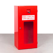A red powder-coated metal fire extinguisher box labeled 'BREATHING APPARATUS' with a visible lever and a small window - fire guard